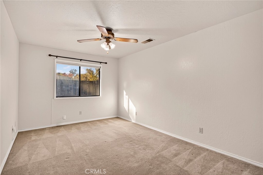 142 Honey Run Road Chico, CA 95928 - Photo 12 of 28 an empty room with a window and ceiling fan