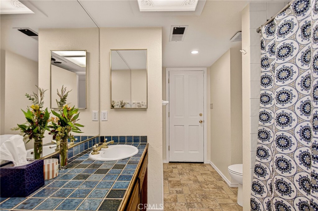 142 Honey Run Road Chico, CA 95928 - Photo 13 of 28 a bathroom with a granite countertop sink and a mirror
