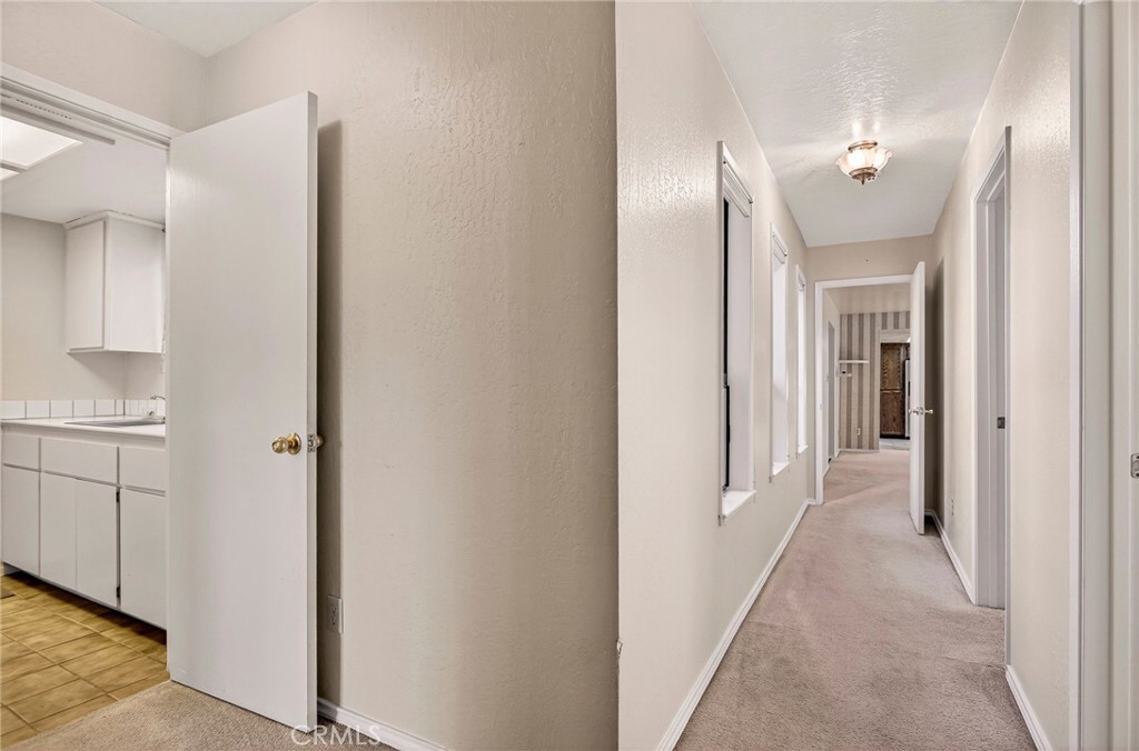 142 Honey Run Road Chico, CA 95928 - Photo 14 of 28 a view of a hallway with closet and wooden floor