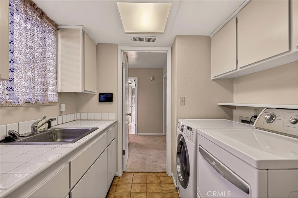 142 Honey Run Road Chico, CA 95928 - Photo 15 of 28 a utility room with sink dryer and washer