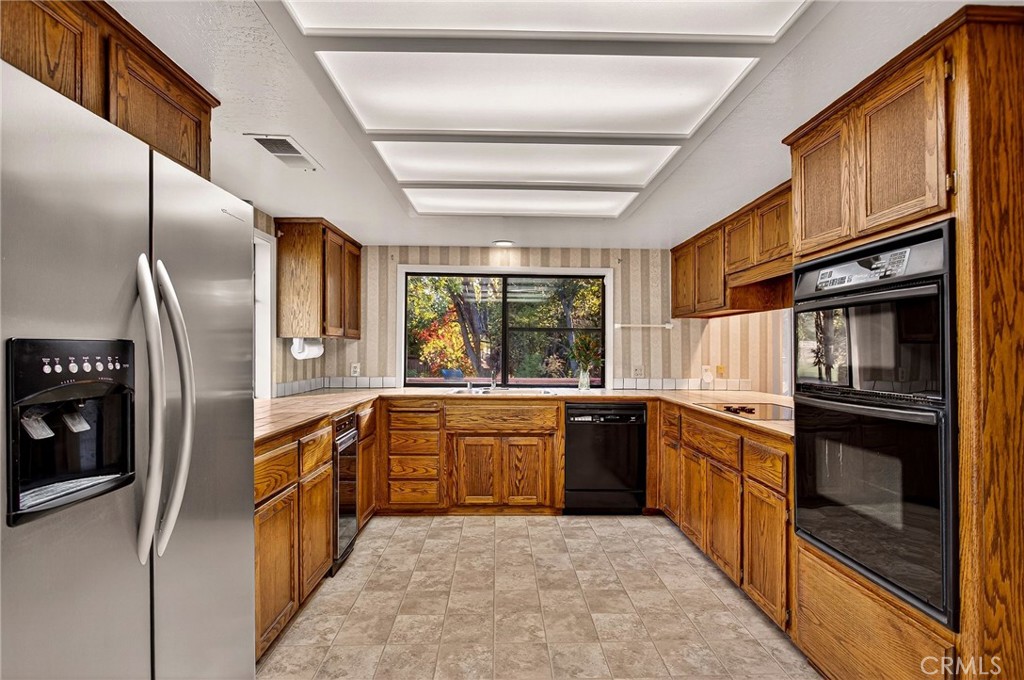 142 Honey Run Road Chico, CA 95928 - Photo 6 of 28 a large kitchen with stainless steel appliances granite countertop a refrigerator a stove and a sink