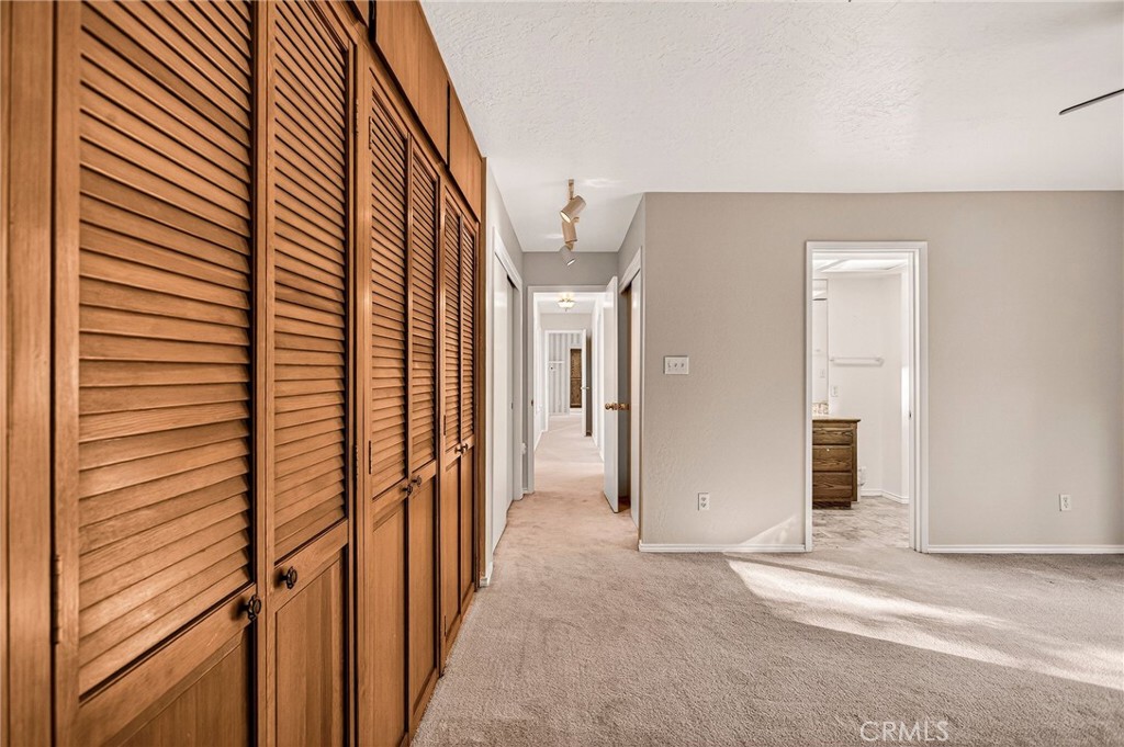 142 Honey Run Road Chico, CA 95928 - Photo 10 of 28 a view of a hallway with wooden shelves