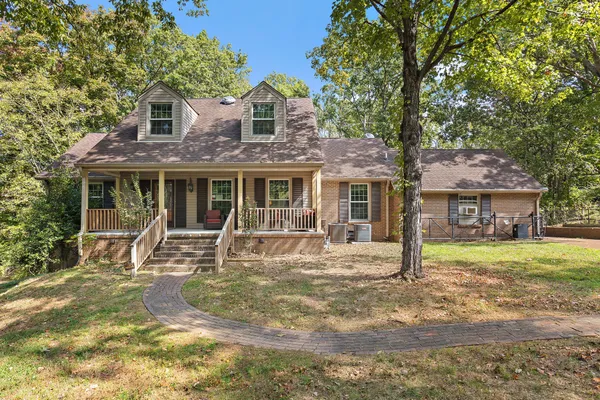 a front view of a house with garden and patio