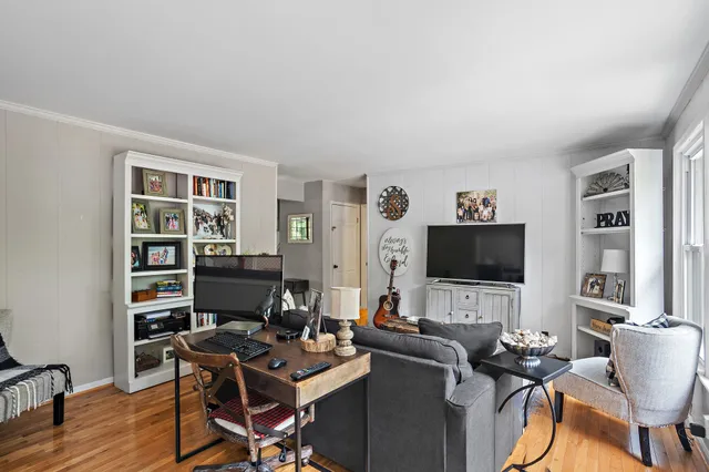 a view of a workspace with furniture and a bookshelf