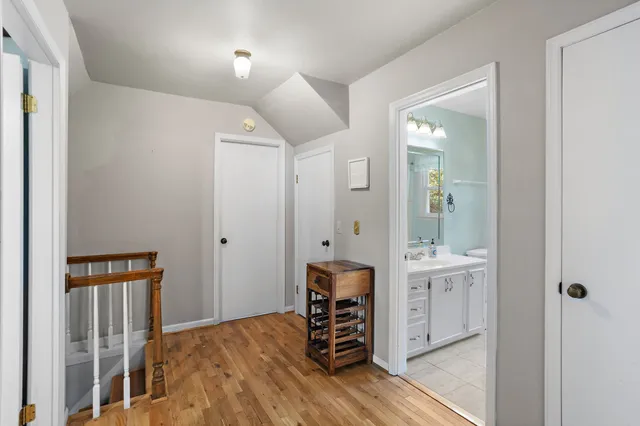 a bedroom with bed and a chandelier