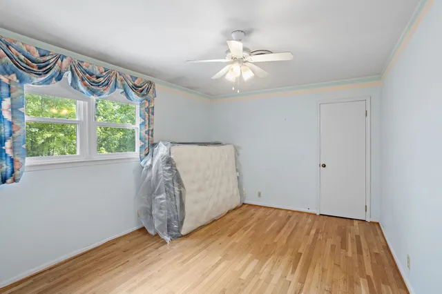 a bedroom with a bed and chair