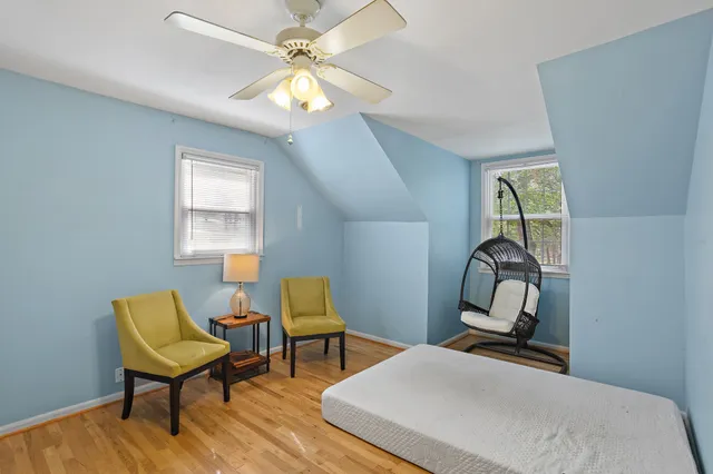 a bedroom with a bed and a ceiling fan