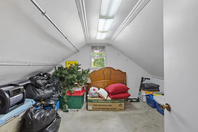 a living room with furniture gym equipment and potted plant