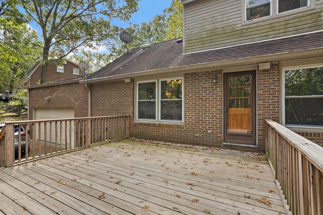 a balcony with wooden floor and fence
