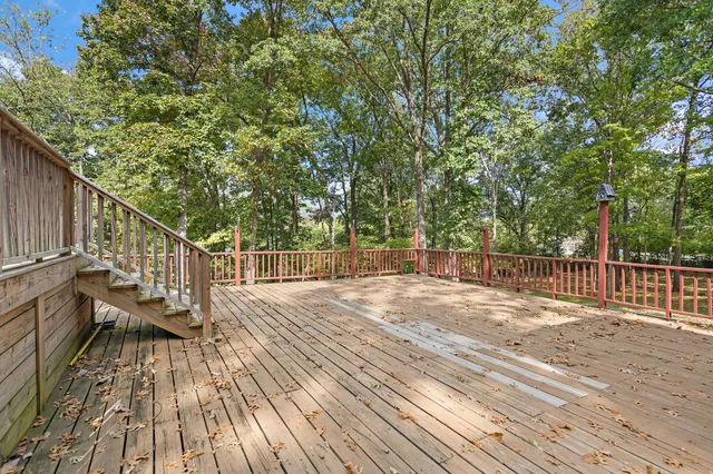a view of a house with wooden floor and fence