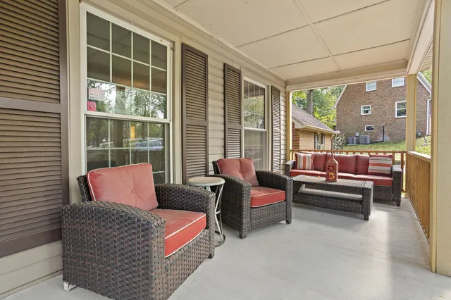 a bedroom with furniture and a large window