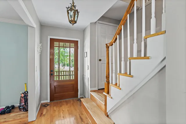 a view of an entryway with wooden floor and door