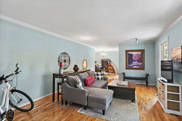 a living room with furniture gym equipment and a flat screen tv