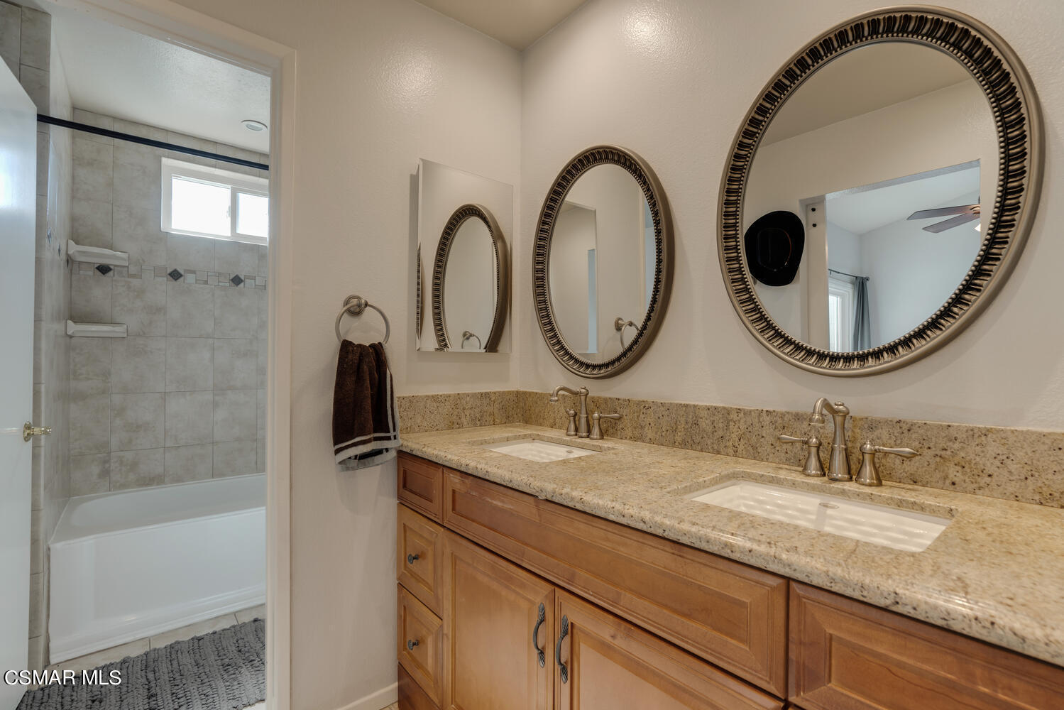 3966 Cochran Street, Unit 75 Simi Valley, CA 93063 - Photo 12 of 21 a bathroom with a granite countertop a sink and a mirror