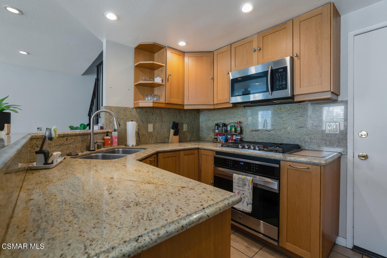 3966 Cochran Street, Unit 75 Simi Valley, CA 93063 - Photo 7 of 21 a kitchen with stainless steel appliances granite countertop a sink stove and microwave