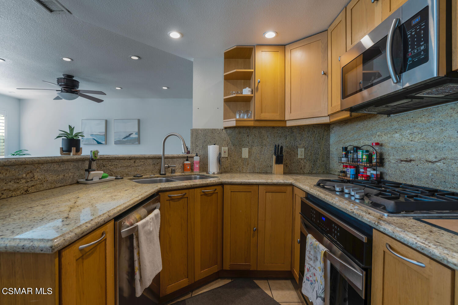 3966 Cochran Street, Unit 75 Simi Valley, CA 93063 - Photo 8 of 21 a kitchen with stainless steel appliances granite countertop a sink a stove and a microwave
