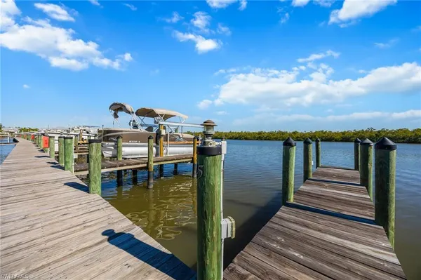 a view of a balcony with wooden floor and lake view
