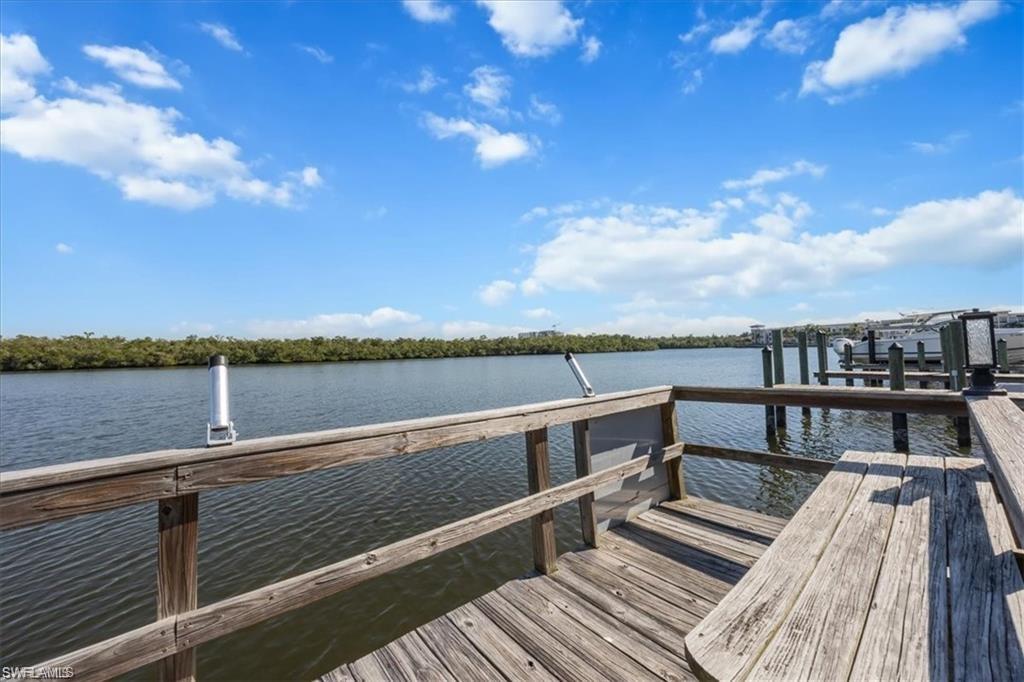 309 Goodlette-Frank Road, Unit A406 Naples, FL 34102 - Photo 19 of 20 a view of a terrace with wooden floor and outdoor seating