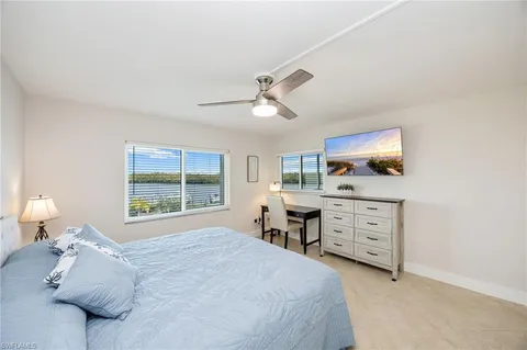 a bedroom with a bed dresser and a window