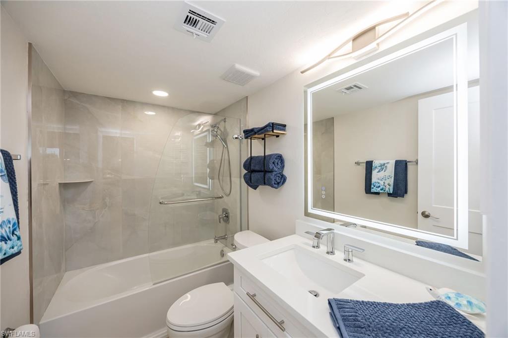309 Goodlette-Frank Road, Unit A406 Naples, FL 34102 - Photo 8 of 14 a bathroom with a granite countertop sink toilet and shower