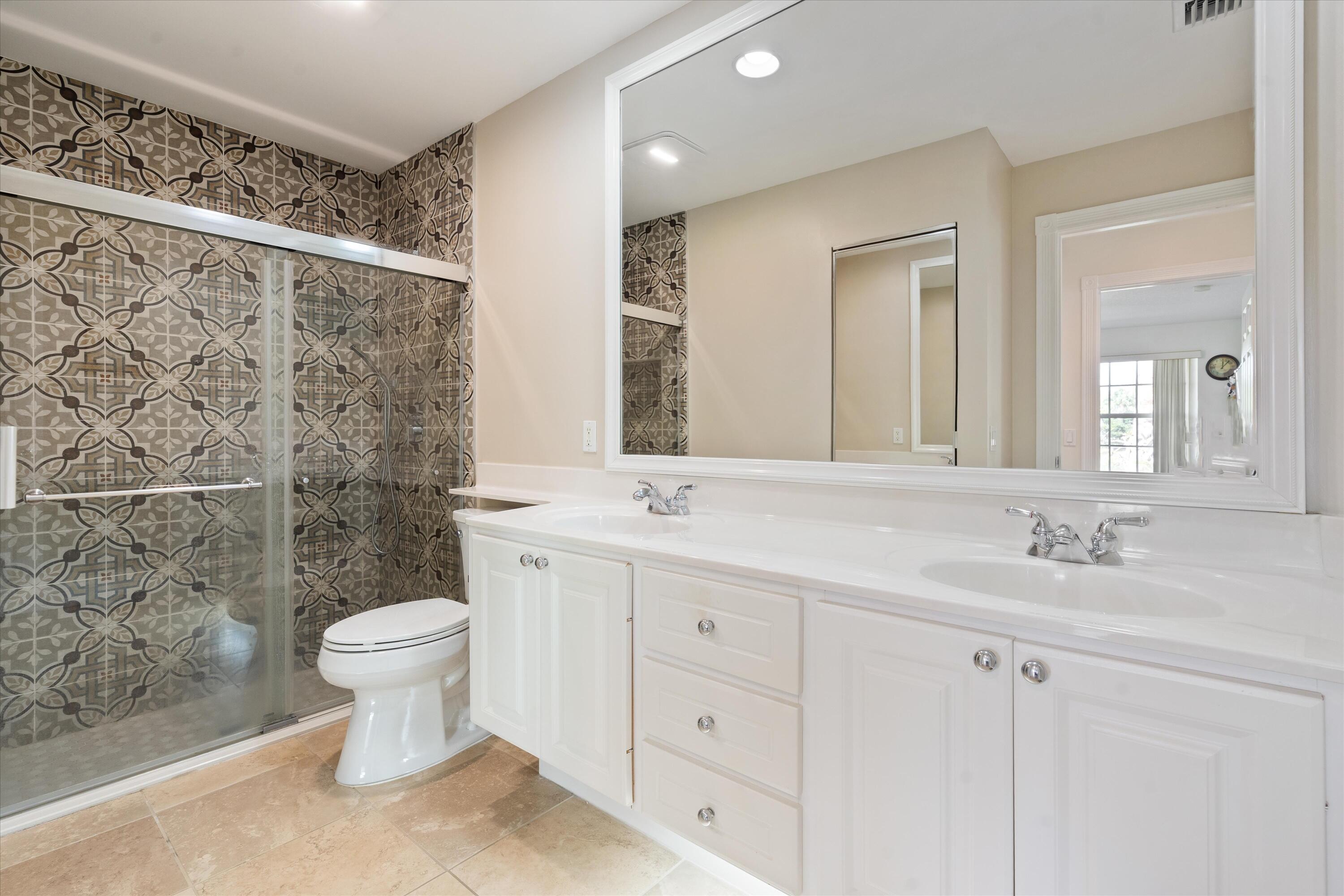 8255 Quito Place Wellington, FL 33414 - Photo 15 of 23 a bathroom with a sink toilet a mirror and shower