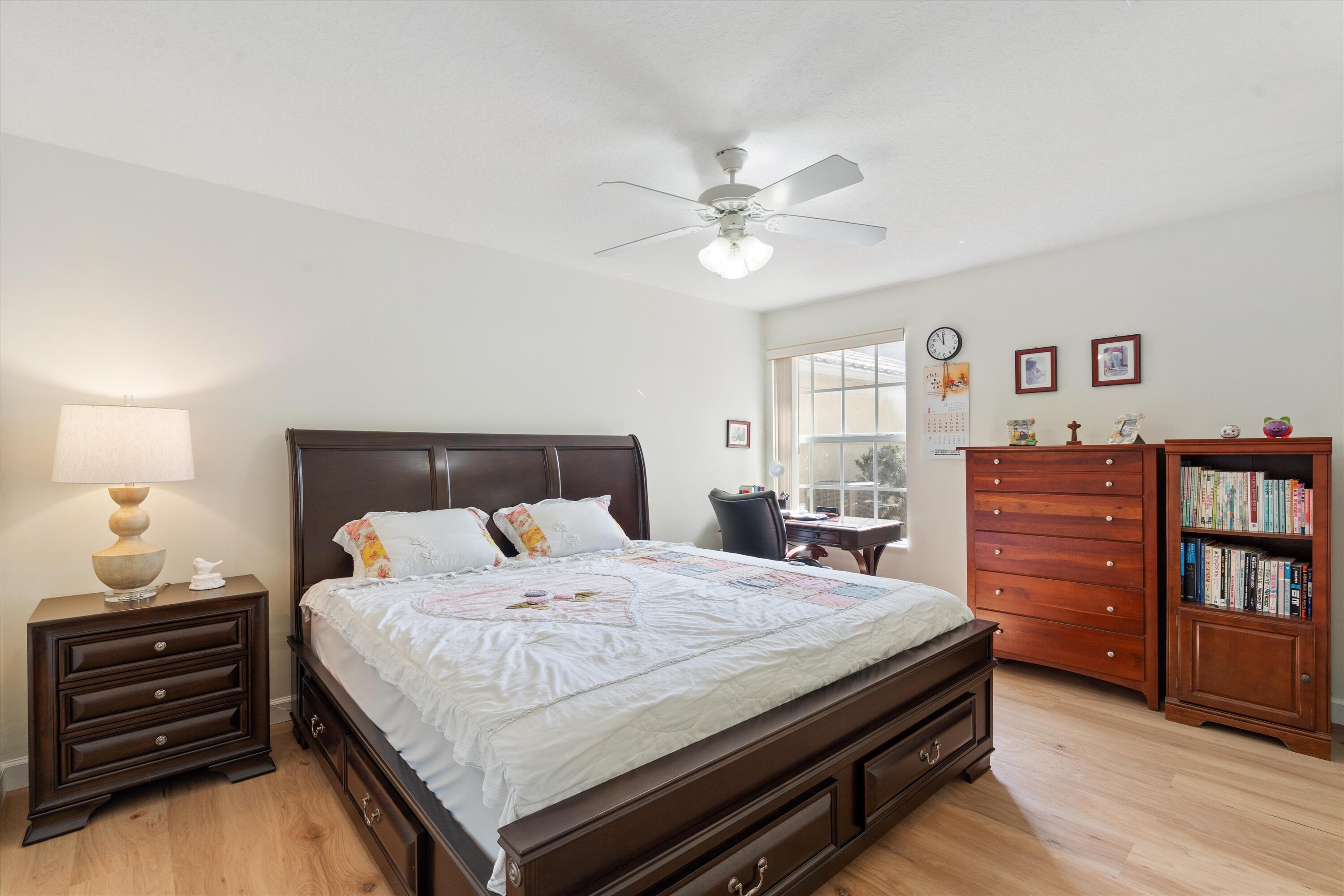 8255 Quito Place Wellington, FL 33414 - Photo 16 of 23 a bedroom with a bed and dresser