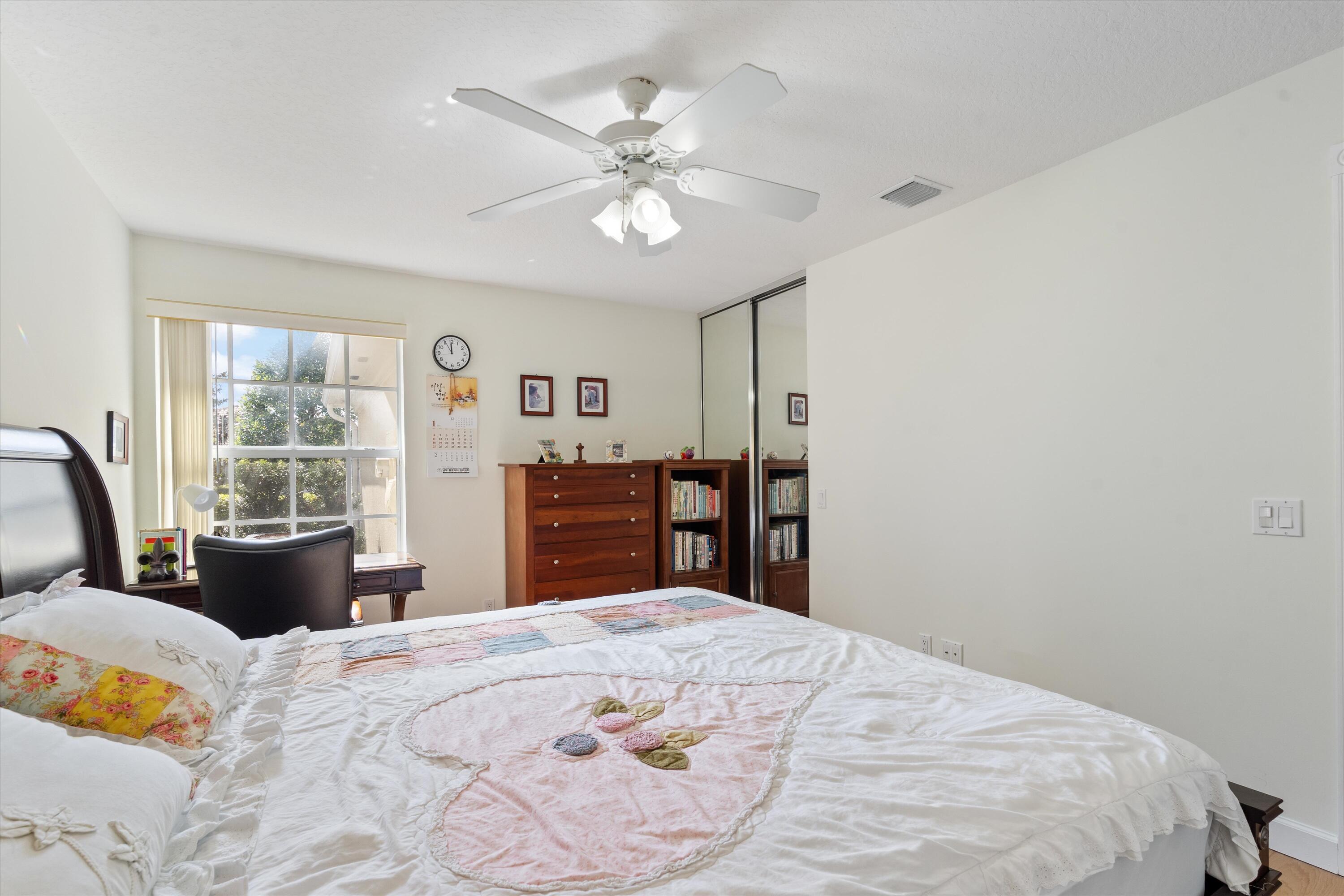 8255 Quito Place Wellington, FL 33414 - Photo 17 of 23 a large bedroom with bed and wooden floor