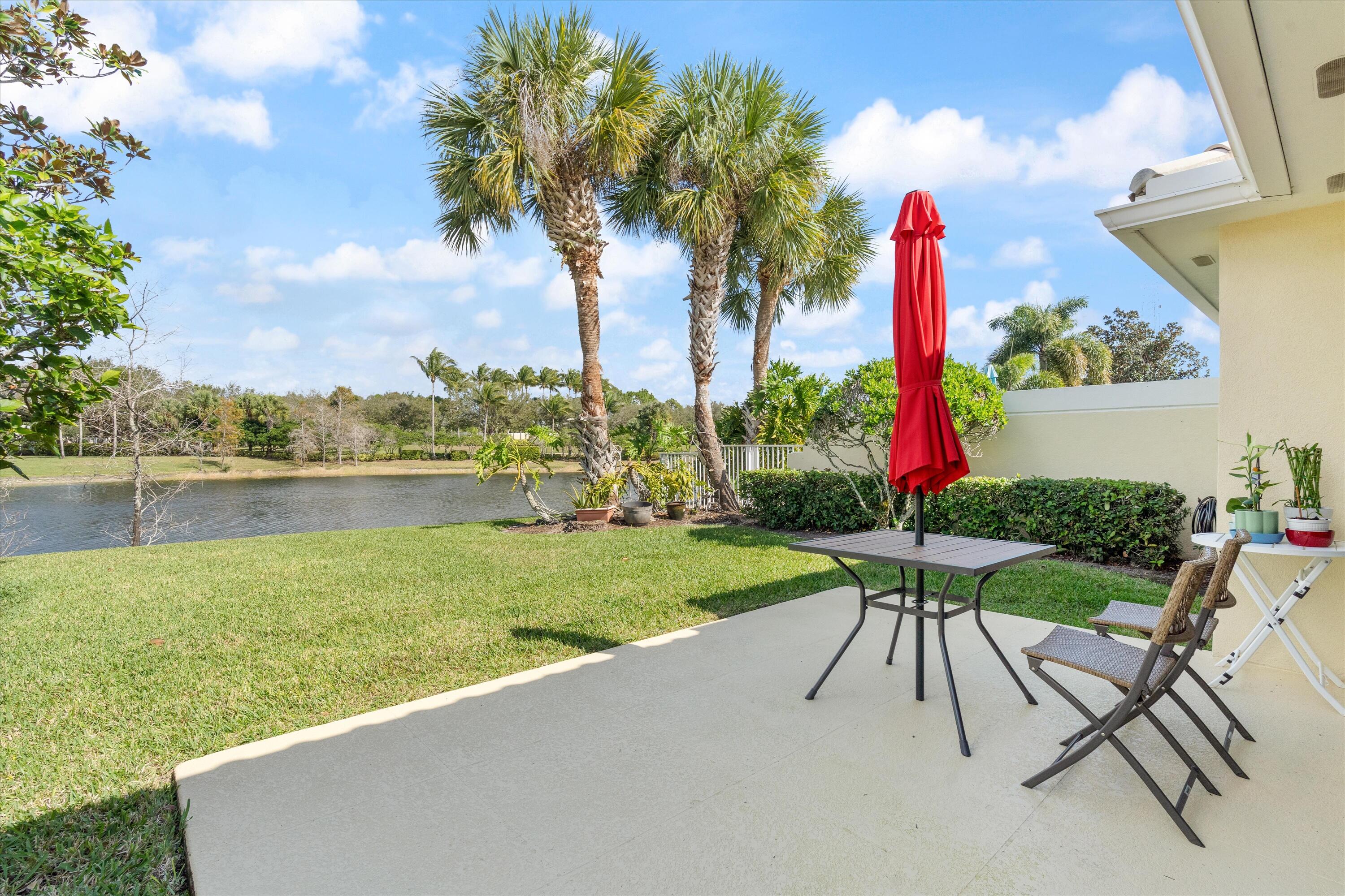 8255 Quito Place Wellington, FL 33414 - Photo 20 of 23 a view of a garden with a table and chairs