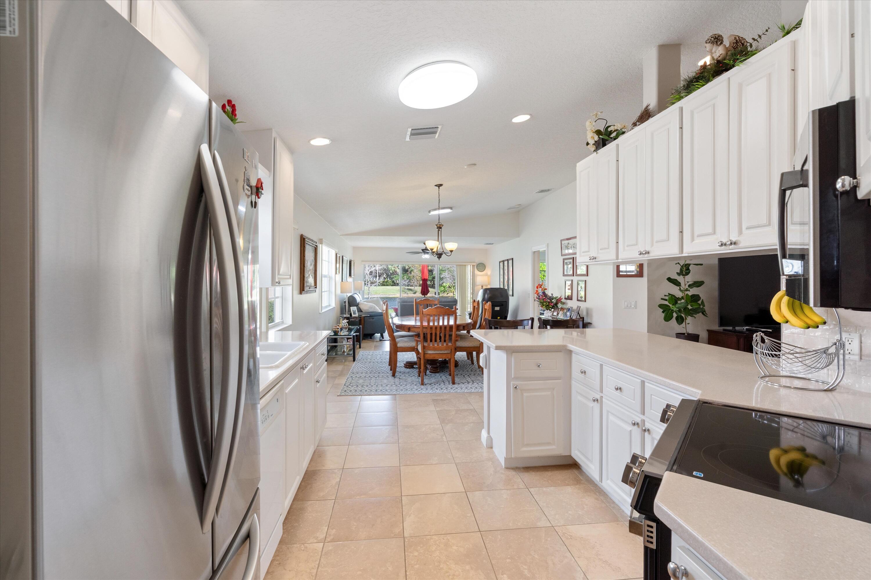 8255 Quito Place Wellington, FL 33414 - Photo 8 of 23 a kitchen with stainless steel appliances a refrigerator and a sink