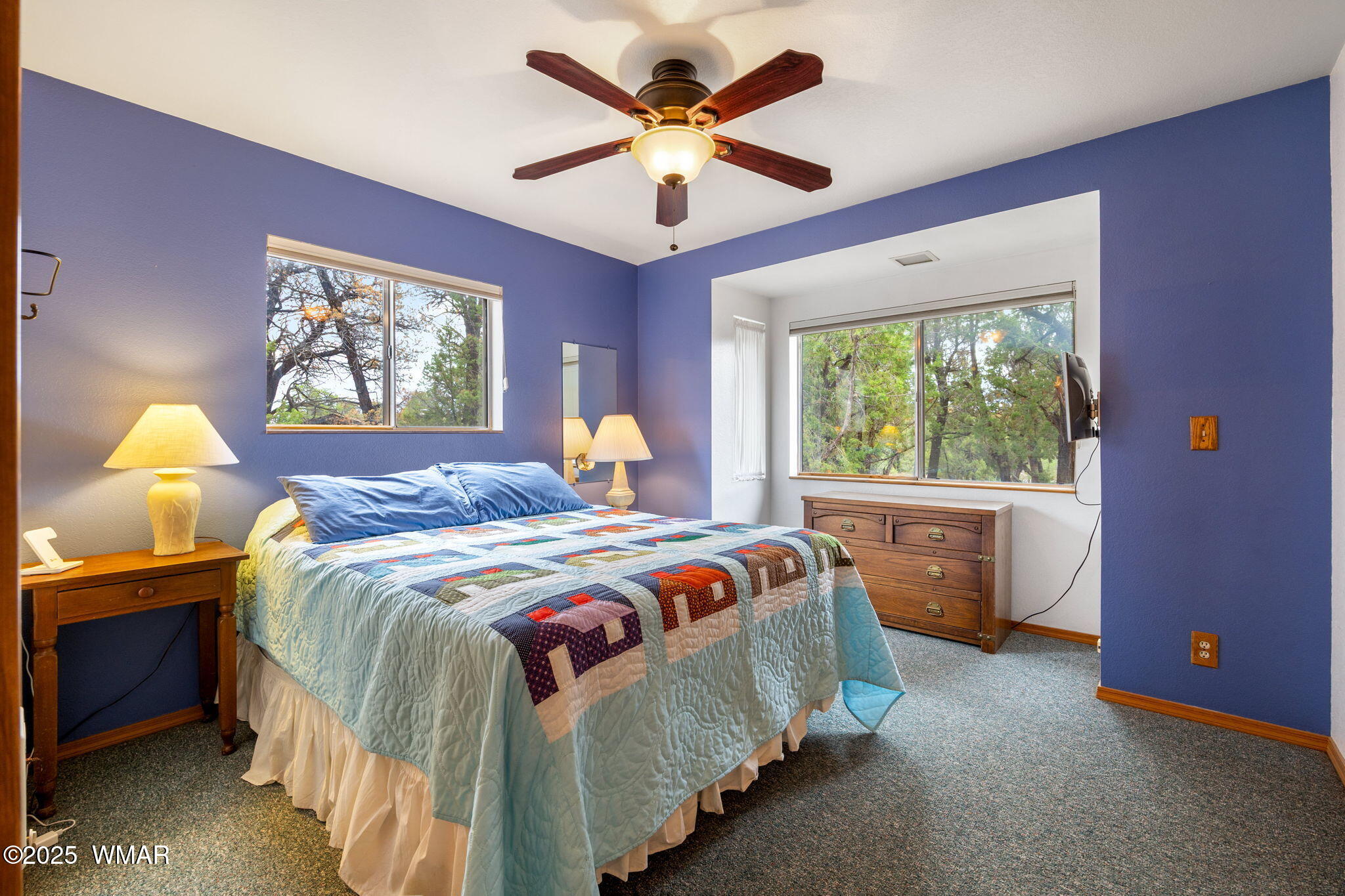 3154 Aspen Road Overgaard, AZ 85933 - Photo 15 of 36 a bedroom with a bed and a chandelier
