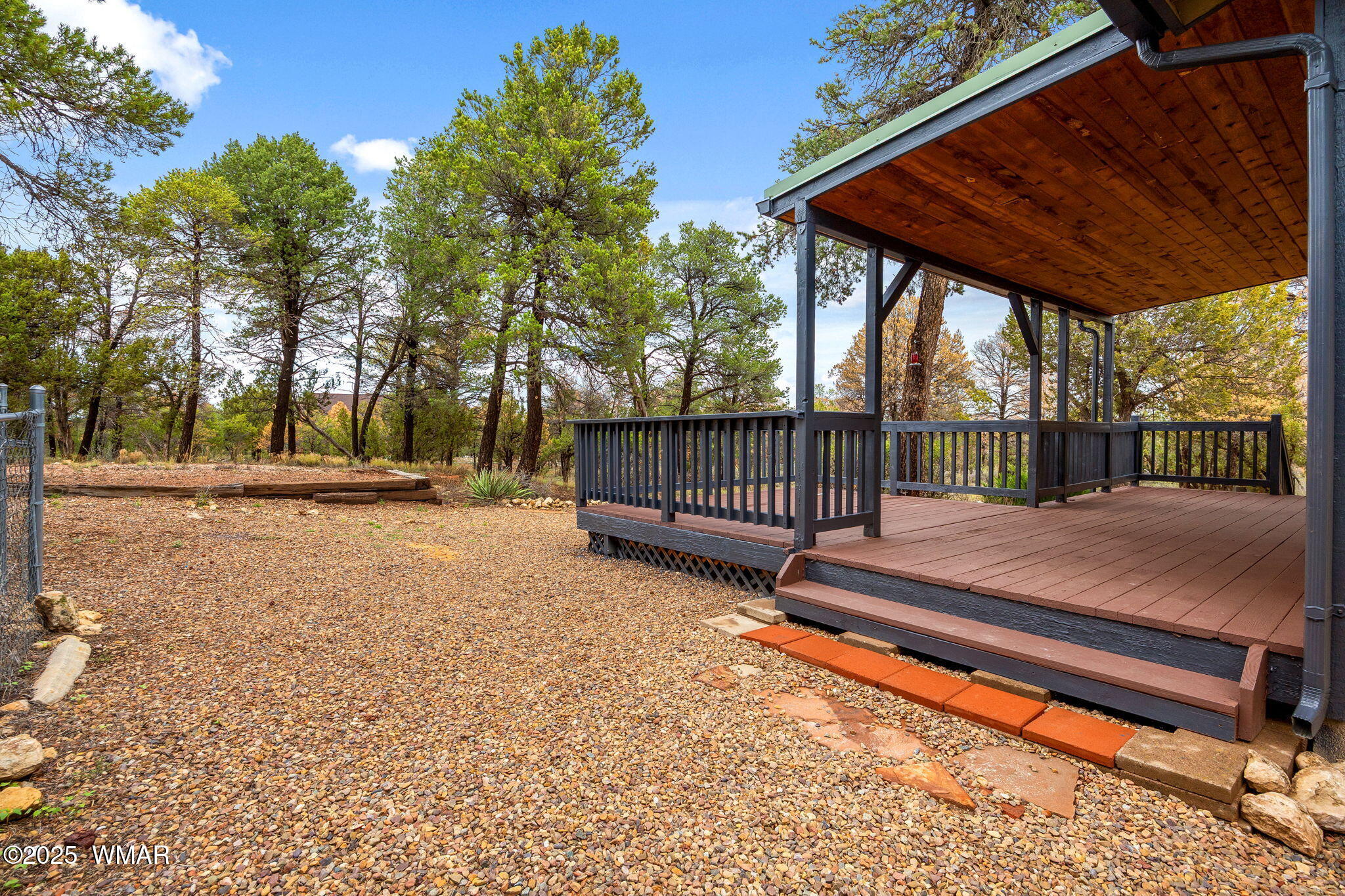 3154 Aspen Road Overgaard, AZ 85933 - Photo 29 of 36 a view of backyard with deck and a garden