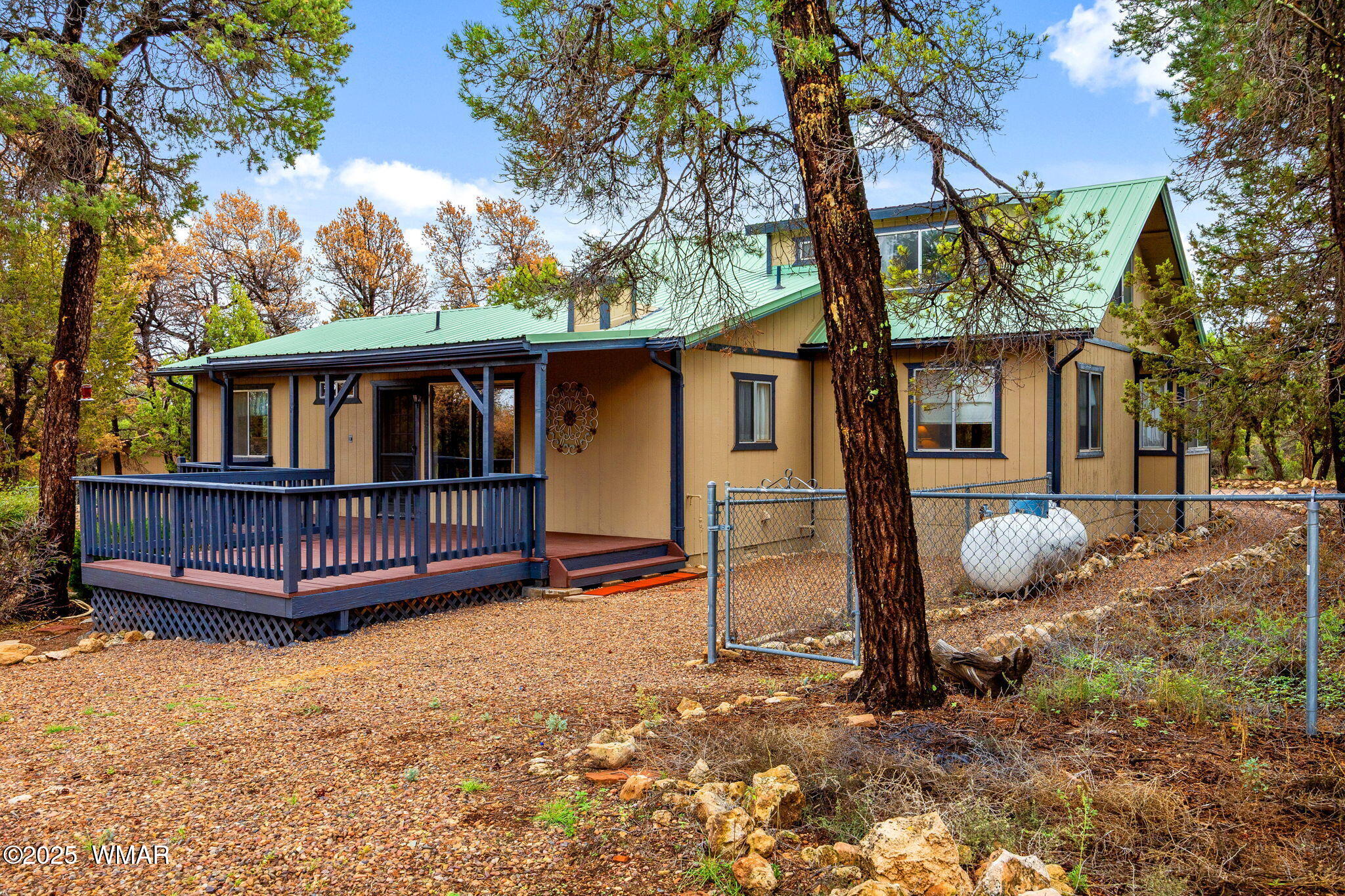 3154 Aspen Road Overgaard, AZ 85933 - Photo 30 of 36 a view of a backyard with a large tree and wooden fence