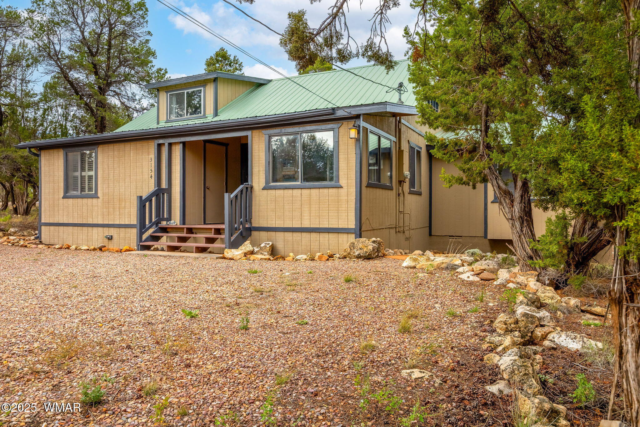 3154 Aspen Road Overgaard, AZ 85933 - Photo 3 of 36 a front view of a house with a yard