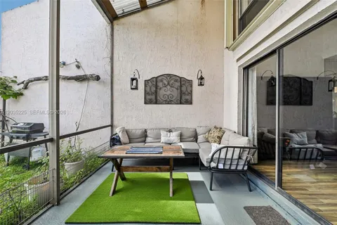a balcony with furniture and a gate