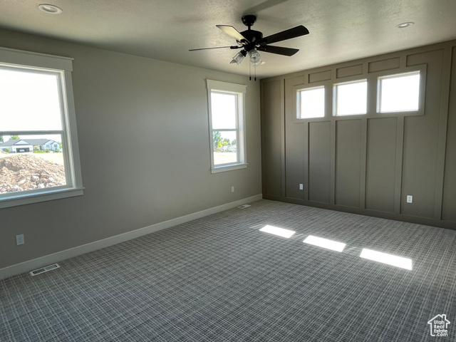 658 West 500 South Logan, UT 84321 - Photo 21 of 25 Carpeted spare room with baseboards and a ceiling fan