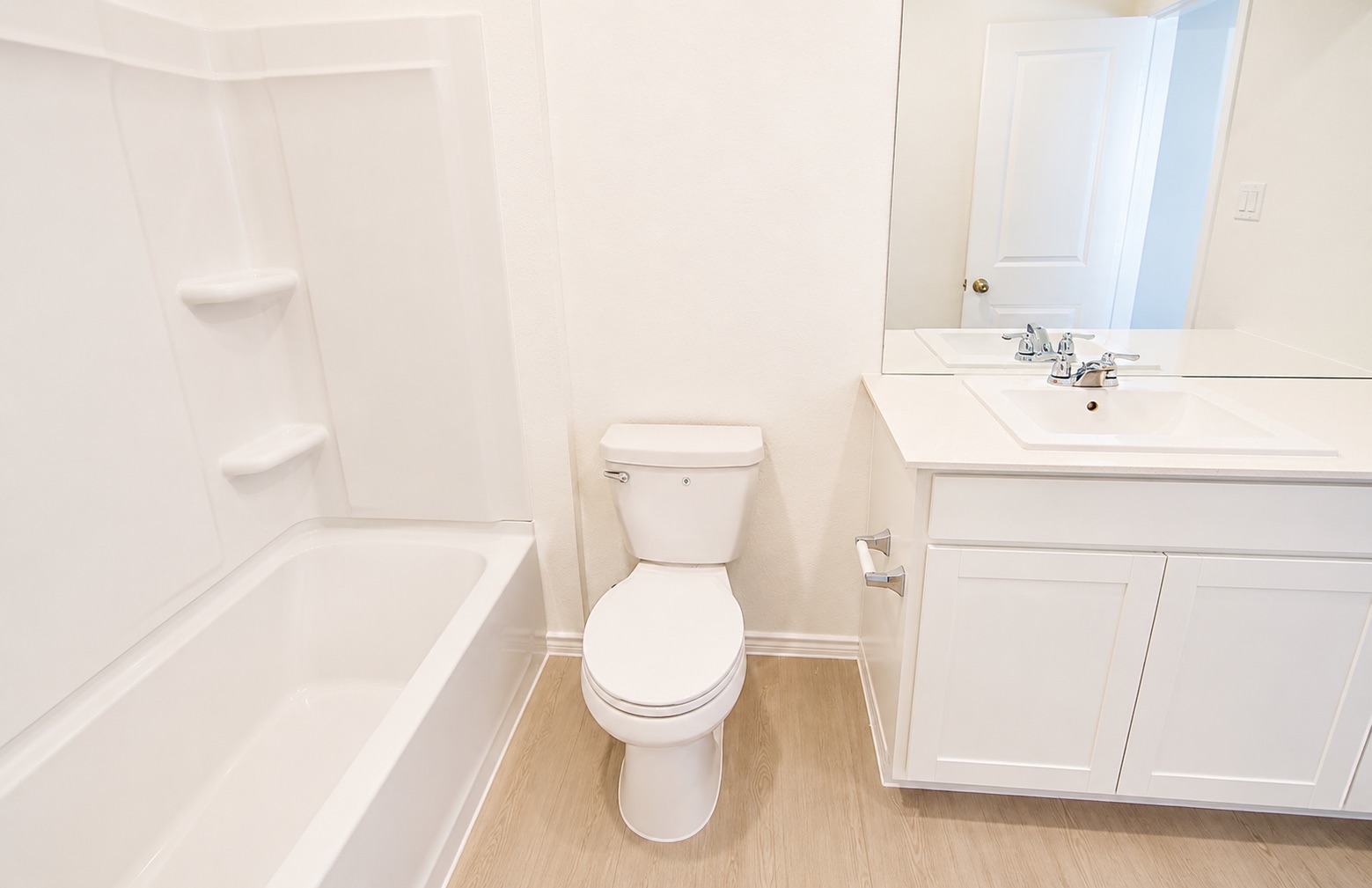 397 Keefer Kyle, TX 78640 - Photo 19 of 33 A well-appointed bath features a bright white tub, toilet, and vanity with a spacious mirror.