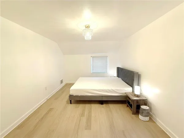 a bed room with a bed and a night stand