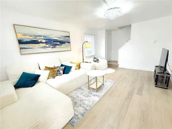 a bedroom with a bed a couch and a flat screen tv
