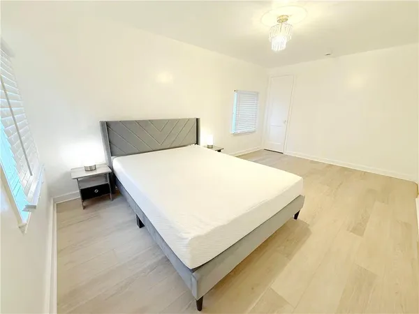 a bedroom with a bed and a night stand