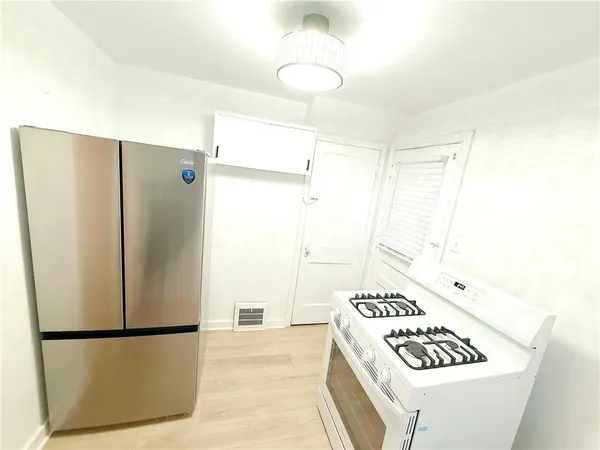 a kitchen with a refrigerator and a stove