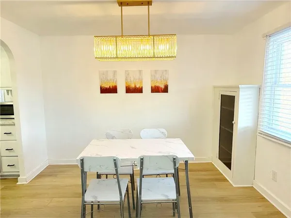 a view of a dining room with furniture and wooden floor