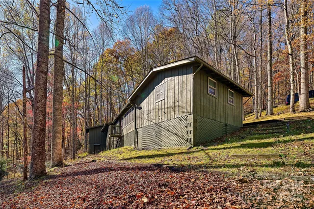a view of wooden house with a trees in the background
