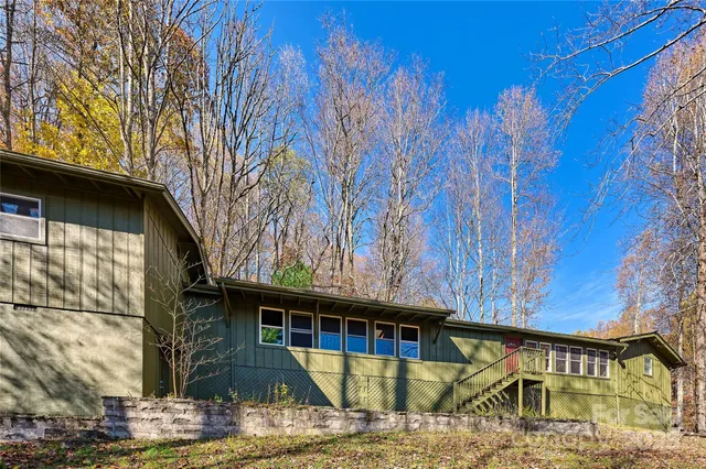 a bedroom with furniture and large windows