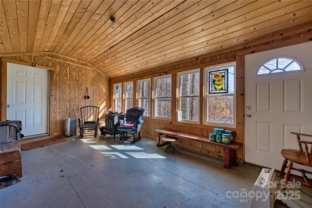 a living room with furniture a flat screen tv and a large window