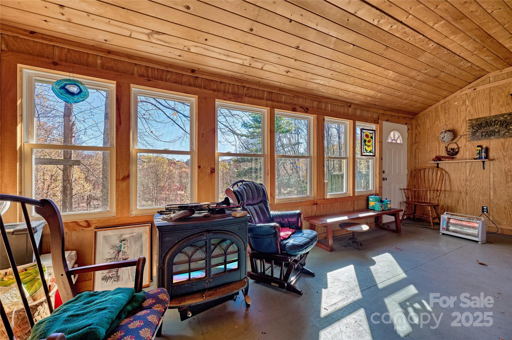 2626 Dendy Orchard Road Highlands, NC 28741 - Photo 28 of 33 a living room with furniture a flat screen tv and a large window