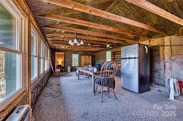 a living room with furniture a wooden floor and next to a window