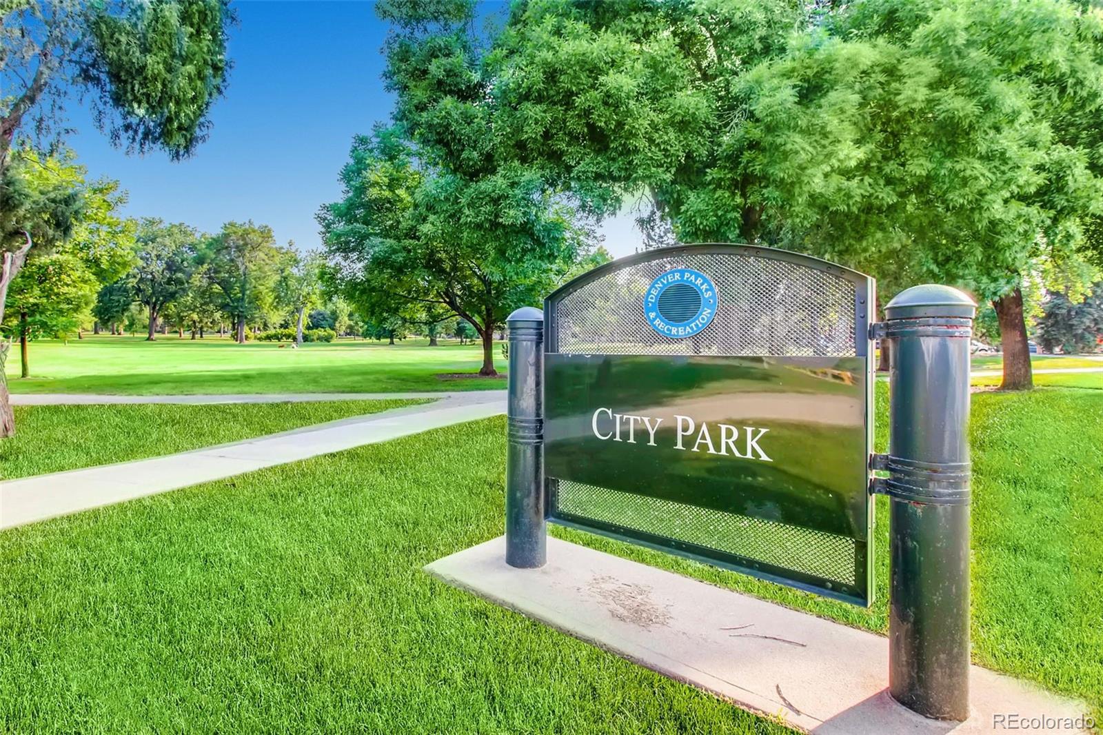 1833 North Williams Street, Unit 206 Denver, CO 80218 - Photo 26 of 29 a wooden bench sitting in the middle of a park