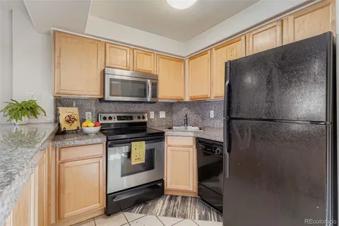 a kitchen with a refrigerator stove and microwave