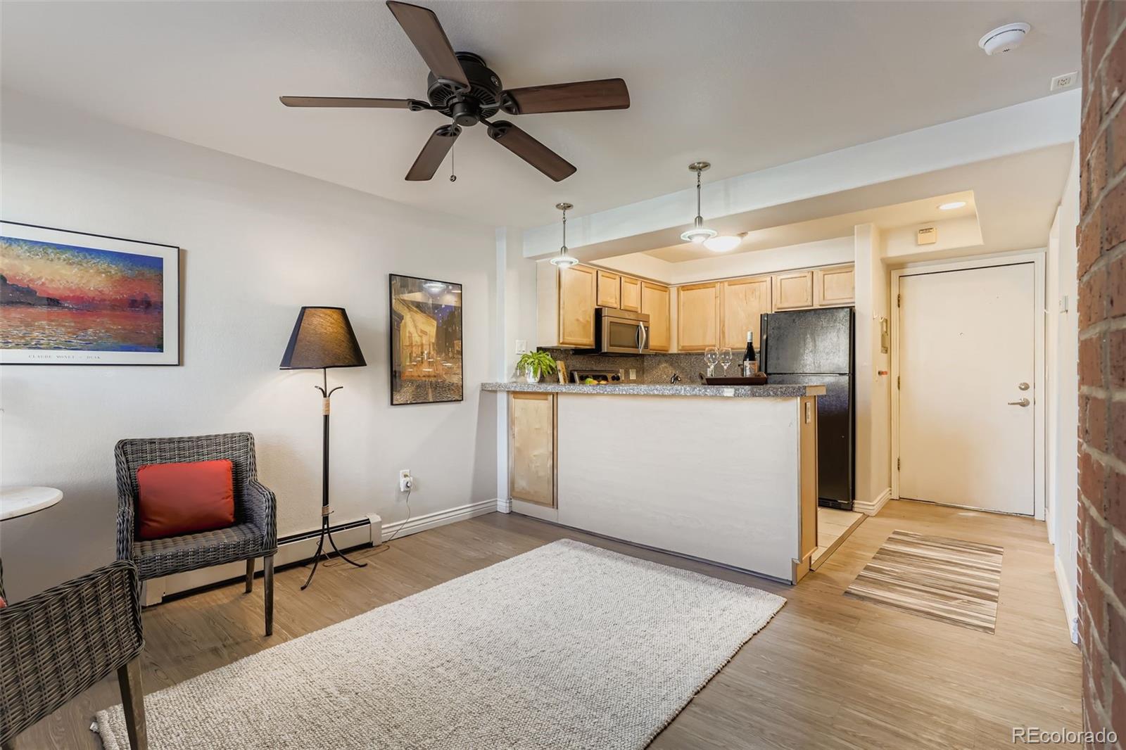 1833 North Williams Street, Unit 206 Denver, CO 80218 - Photo 7 of 29 a kitchen with stainless steel appliances kitchen island a refrigerator sink and cabinets