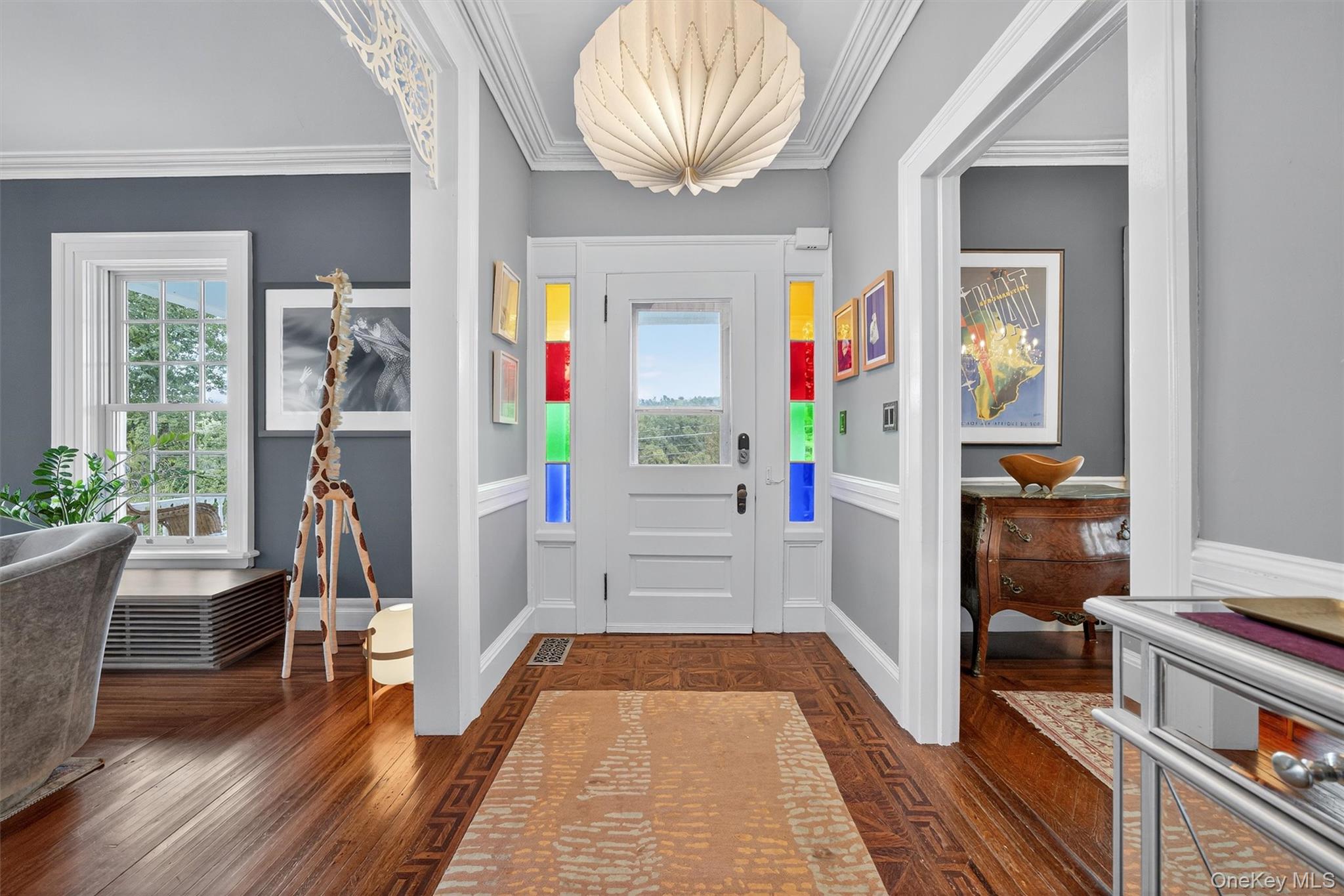 1657 River Road Damascus, PA 18415 - Photo 6 of 43 Foyer entrance featuring ornamental molding, dark wood-style floors, a wainscoted wall, and a decorative wall